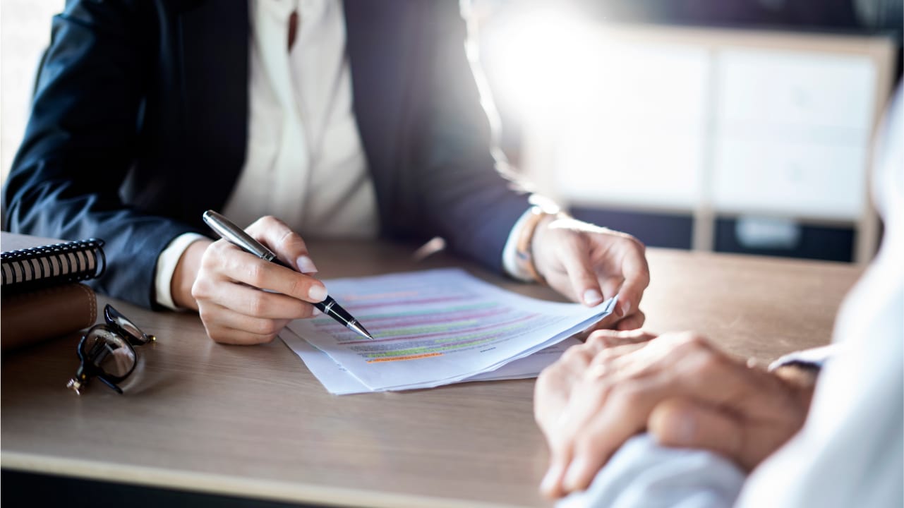 Lawyer reviewing paperwork with client