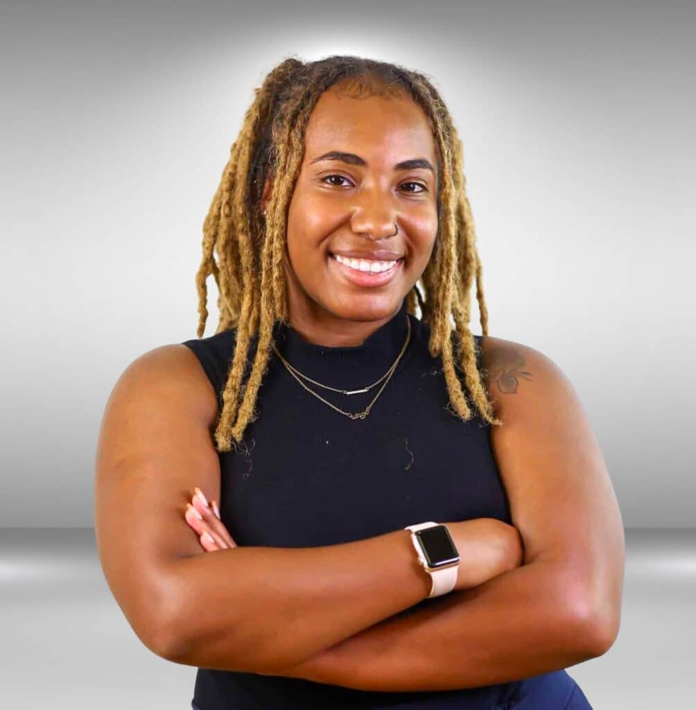 Image of Lyric Gay dressed in a black shirt with navy blue dress pants