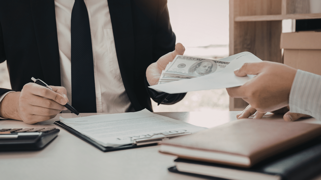 Image of a professional taking cash from other professional