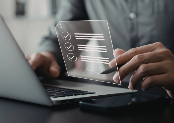 Person sitting in front of a laptop with the checklist see-through image above the laptop
