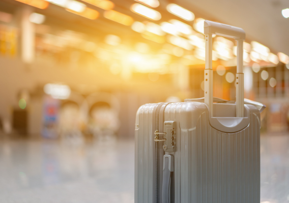 Silver suitcase at airport with light shining in background.
